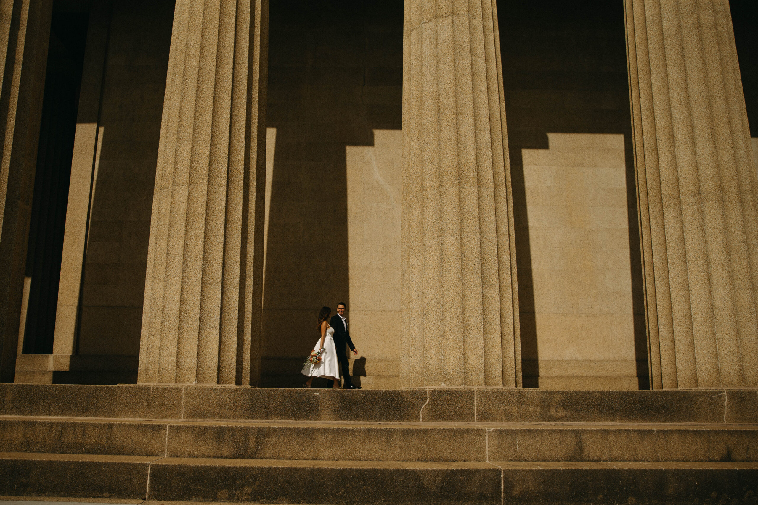 a couple during their elopement at the parthenon