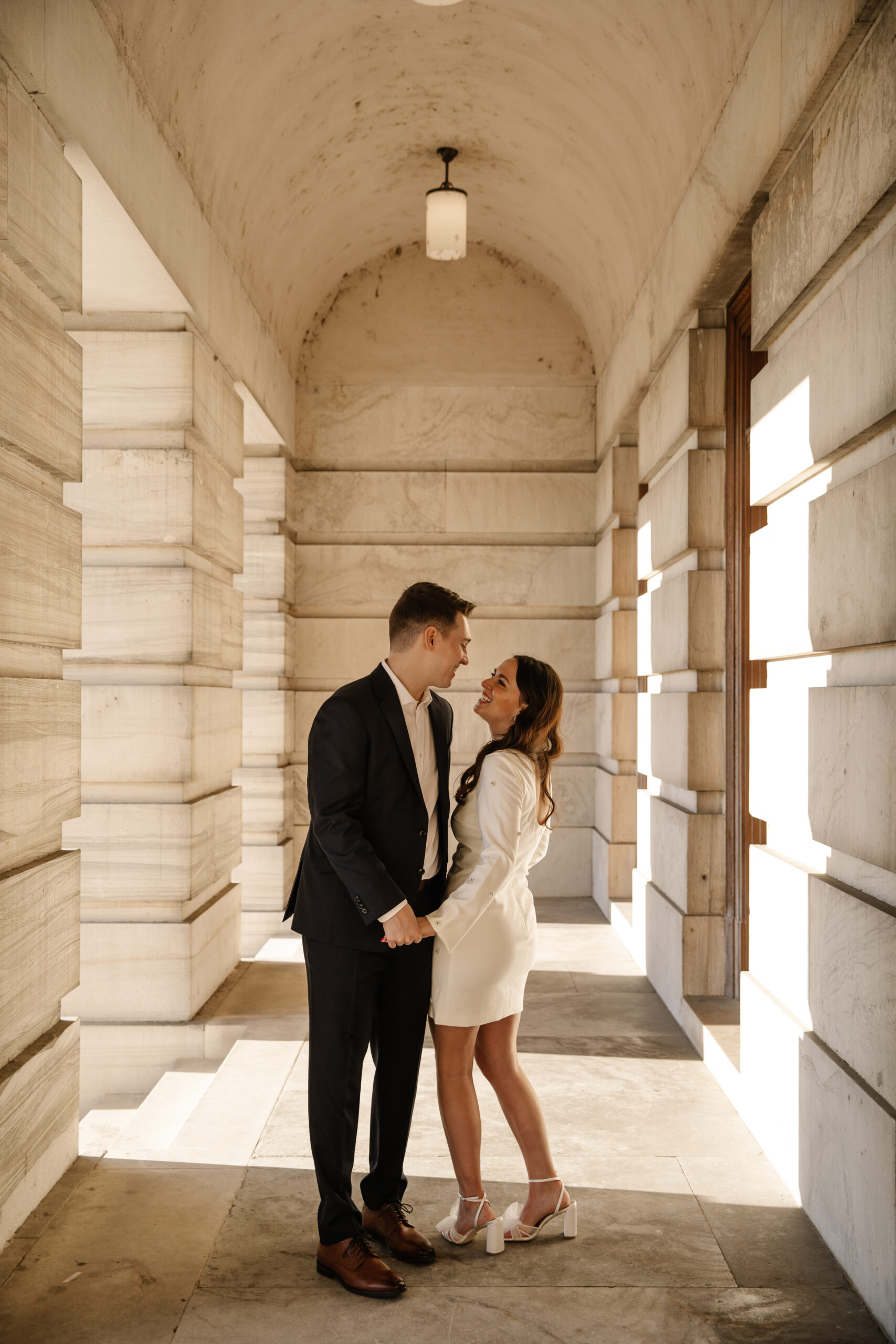 couple taking engagement photos at the War Memorial & Tennessee State Capitol Grounds in Nashville Tennessee